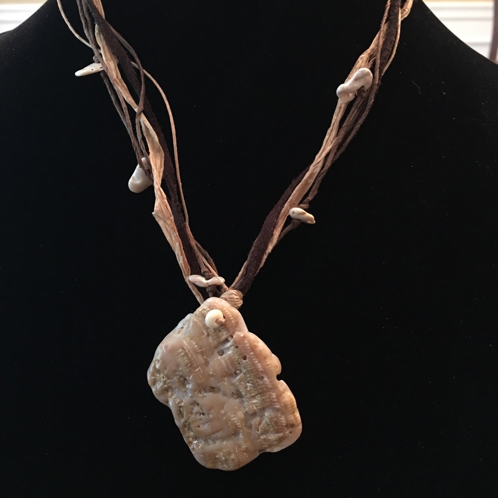 Beach on a string. Shell, leather, hemp, paper.